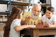 © zinkevych - Smiling grandfather and grandson doing a jigsaw puzzle together