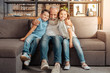 © zinkevych - Happy loving grandfather cuddling grandchildren on couch