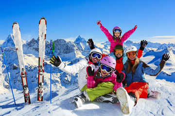 Fototapete - Happy family enjoying winter vacations in mountains . Ski, Sun, Snow and fun.