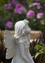 Fairy Statue In Profile With Garden Backdrop