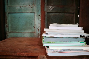 books on the wooden table in the old library. Selective focus with blurred wooden background.