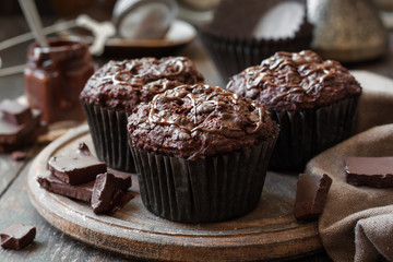 Wall Mural - chocolate muffins on a wooden background