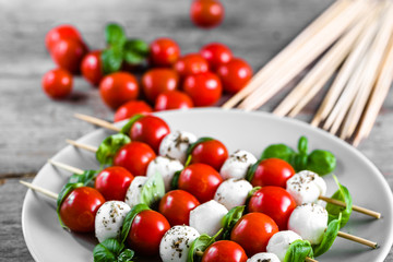 Caprese salad - skewer with tomato, mozzarella and basil, italian food and healthy vegetarian diet concept