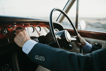 Inside View Of Classic Luxury Car Being Driven By Man.