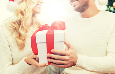 Wall Mural - close up of couple with christmas gift at home