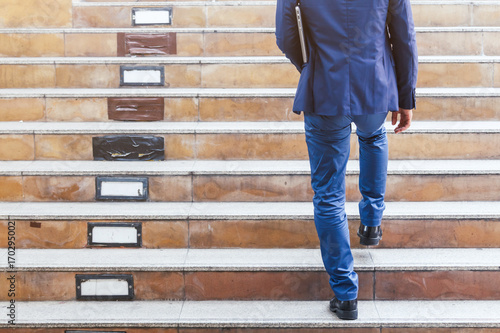 Fotografía Businessman walking up the stairs