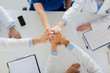 © Syda Productions - group of doctors making high five at table