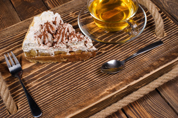 Wall Mural - cake with tea on wooden desk