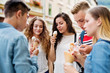 © Halfpoint - Attractive teenage students in town eating ice cream.