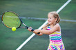 © famveldman - Child playing tennis on outdoor court