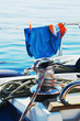 sailboat equipment, winch with blue orange shorts