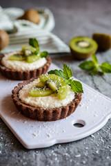 Wall Mural - Chocolate tartlets filled with coconut cream and topped with kiwi slices