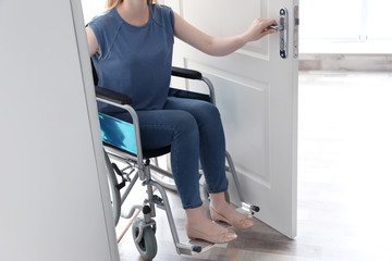 Young woman in wheelchair at home