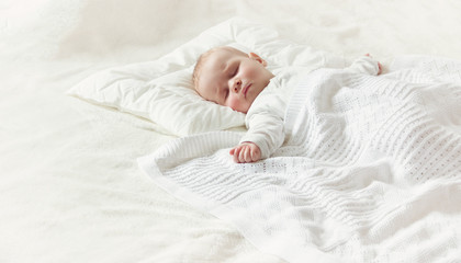 Wall Mural - Baby sleeping covered with soft blanket