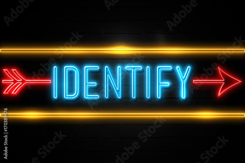 Fotografía Identify - fluorescent Neon Sign on brickwall Front view