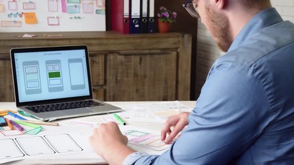 Mobile app developer creating smartphone application layout