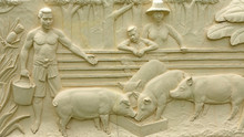 Native Thai Culture Stone Carving On Temple Wall.