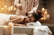 © Cookie Studio - Tender african girl relaxing enjoying healthy spa massage with oil.