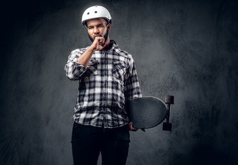 Sticker - A man holds long board over grey background in a studio.