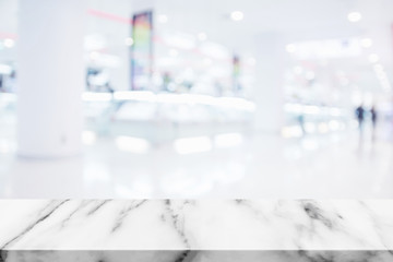 Poster - Empty top of marble table with blur shopping mall background.