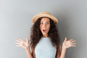 Wall Mural - Surprised woman in hat looking camera