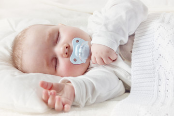 Wall Mural - Baby sleeping covered with soft blanket