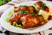 Stuffed Cabbage With Meat And Rice Served With Boiled Potatoes And Tomato Sauce