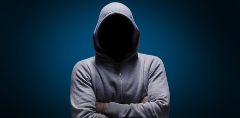 composite image of hacker standing with arms crossed