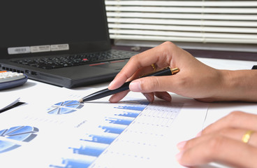 Wall Mural - Business checking documents on office table with calculator and graph financial.