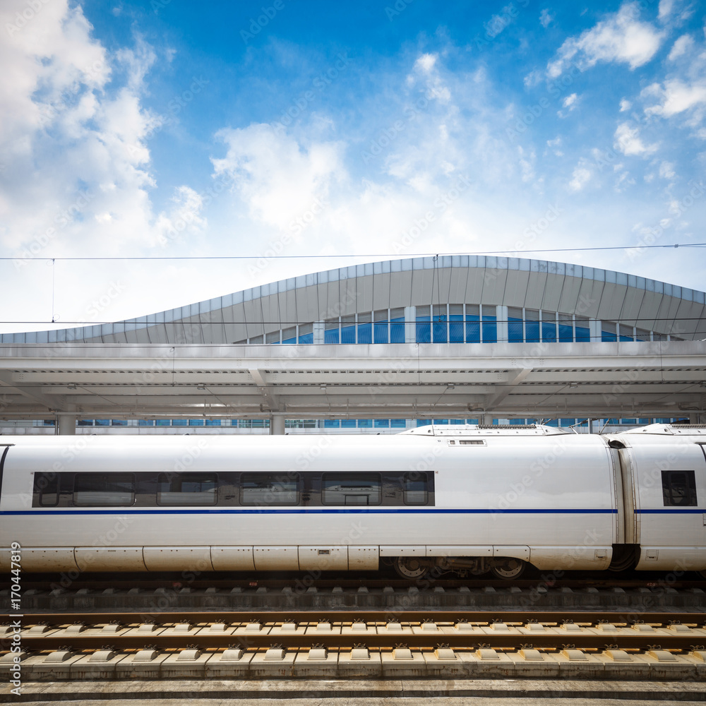 Modern high speed train at the railway station with motion blur effect ...