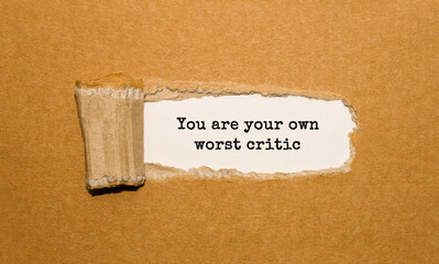 Wall Mural - The text You are your own worst critic appearing behind torn brown paper