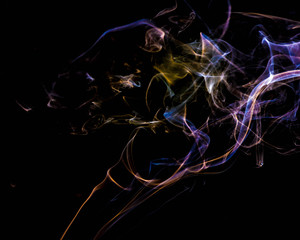 Wall Mural - multicolored smoke dissipates in the air on an isolated black background