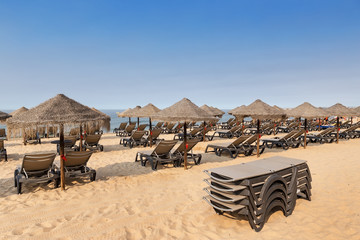 Wall Mural - Beach with sunbeds and umbrellas holiday feeling, Portugal.