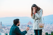 © Emma - Young man proposing to his girlfriend against view of Florence from above