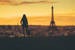 © Khritthithat - Beautiful silhouette girls posting and holding shopping bag, and standing outdoors at Eiffel tower.