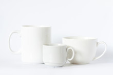Three White Cups Of Different Size And Design, Clean Tea Mug And Coffee Cups