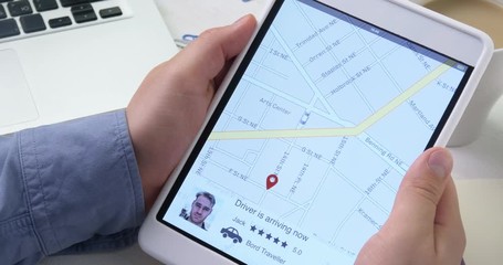 Using car sharing app on the digital tablet. Man arrives to pick up his passenger