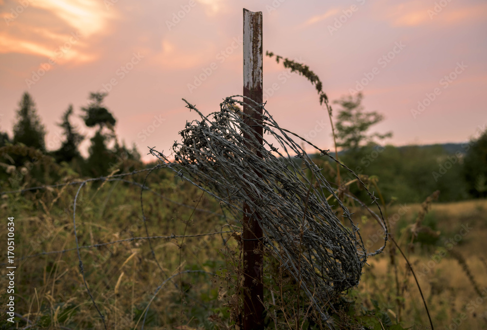 Barbed wire hung on an old fence post on a farm in Washington Stock ...