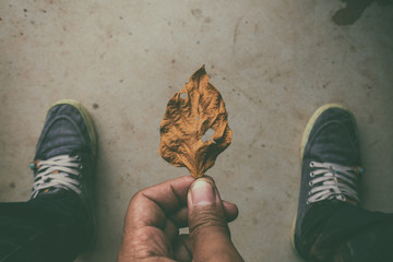 Wall Mural - a man Looking down on feet, selective focus