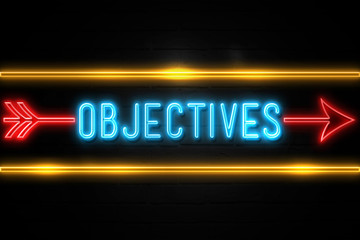 Objectives  - fluorescent Neon Sign on brickwall Front view