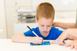 © dobok - preschooler child boy learn to write letter in the classroom