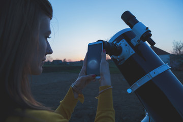 Wall Mural - photographing the moon through a telescope with cellphone.