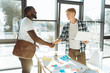 © zinkevych - Positive office worker shaking hands of a new emploee