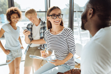 Positive international students talking together