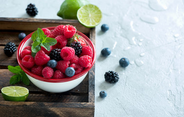 Wall Mural - Fresh summer berries, raspberry, blueberry, blackberry in a bowl, raw vegan eating