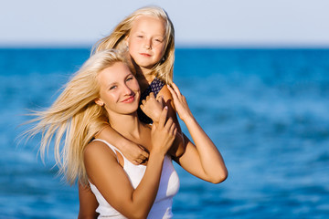 Happy family during summer vacation on white beach