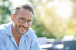 © goodluz - Portrait of smiling mature man with eyeglasses