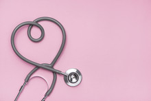 Medical Concept. The Stethoscope With Heart Shape On Pink Background.