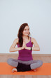 © evelinphoto - Healthy lifestyle. The girl is practicing meditation on the gym mat in yoga class. Relaxation and Stretching. Young slim sporty girl holds her hands in Namaste posture! Woman do yoga lotus position.