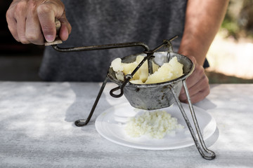 Canvas Print - young man mashing boiled potatoes